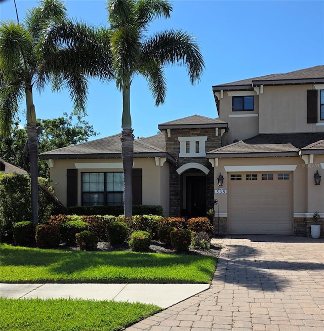 535 Honeyflower Loop, Bradenton, FL 34212 - view of front of property with stone siding, stucco siding, decorative driveway, and a garage