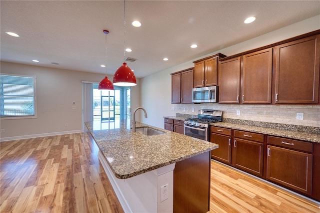 11924 Persian Ter, Bradenton, FL 34212 - kitchen featuring stainless steel appliances, a sink, light wood-type flooring, decorative backsplash, and recessed lighting