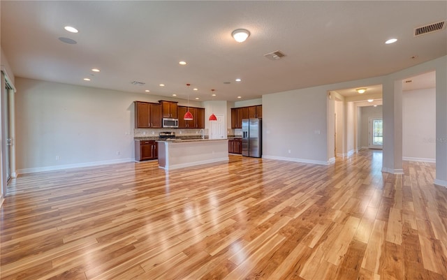 11924 Persian Ter, Bradenton, FL 34212 - unfurnished living room with light wood-type flooring, recessed lighting, and baseboards