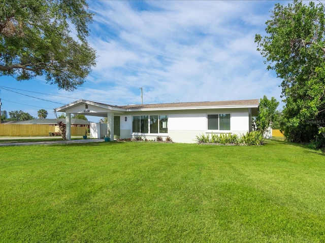 6116 Rodgers Ave, Sarasota, FL 34231 - view of front facade featuring fence, a front yard, and an attached carport