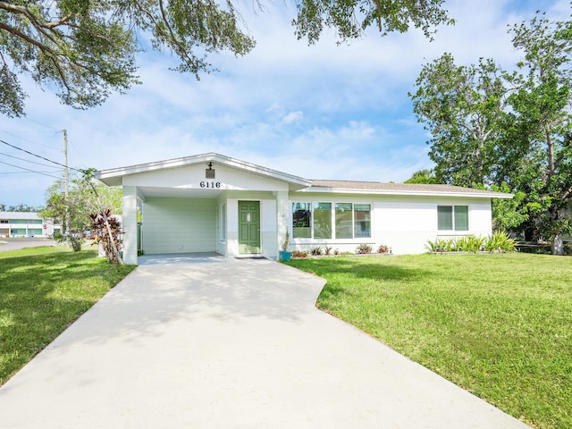 6116 Rodgers Ave, Sarasota, FL 34231 - view of front facade featuring concrete driveway, a front yard, and an attached carport
