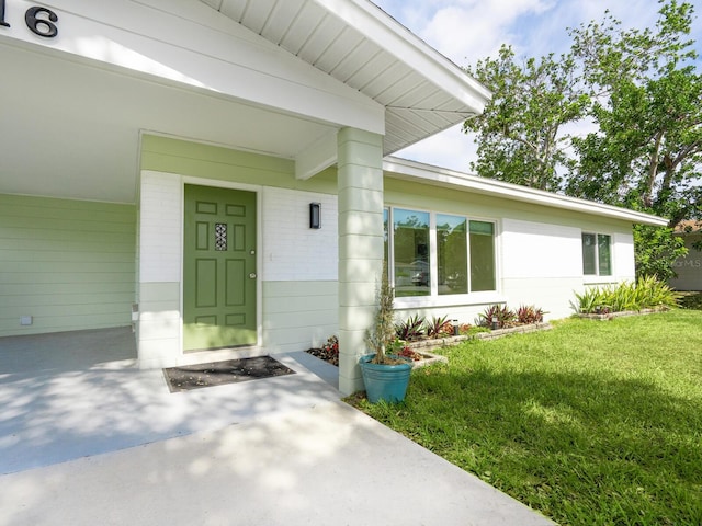 6116 Rodgers Ave, Sarasota, FL 34231 - doorway to property featuring a yard