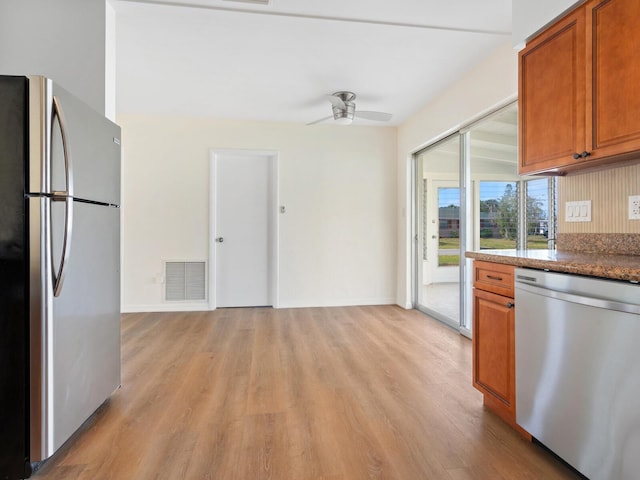 6116 Rodgers Ave, Sarasota, FL 34231 - kitchen featuring visible vents, light wood-style flooring, brown cabinets, and stainless steel appliances