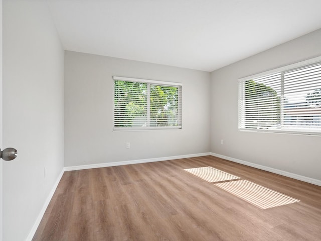 6116 Rodgers Ave, Sarasota, FL 34231 - empty room with baseboards and wood finished floors