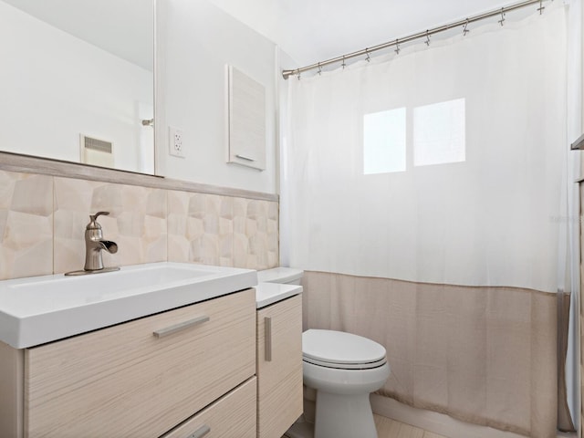 6116 Rodgers Ave, Sarasota, FL 34231 - bathroom with vanity, visible vents, wainscoting, toilet, and a shower with shower curtain