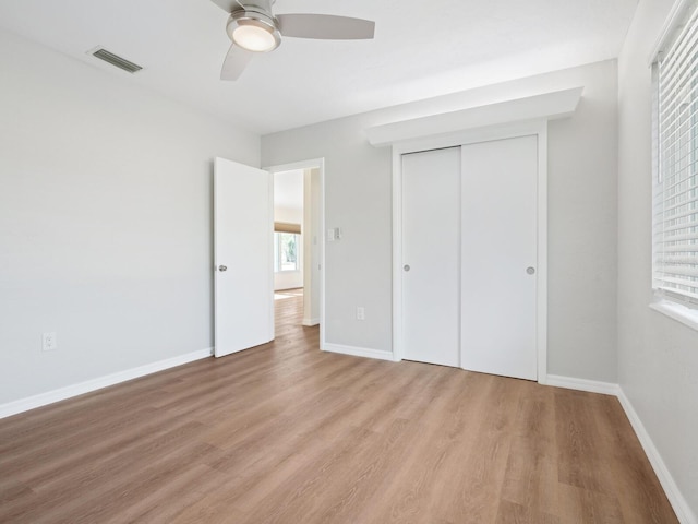 6116 Rodgers Ave, Sarasota, FL 34231 - unfurnished bedroom with baseboards, a closet, wood finished floors, and visible vents