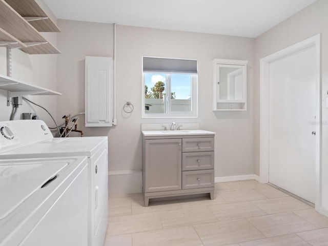 6116 Rodgers Ave, Sarasota, FL 34231 - washroom featuring a sink, baseboards, and washer and clothes dryer