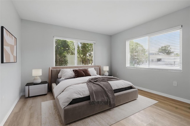 6116 Rodgers Ave, Sarasota, FL 34231 - bedroom featuring multiple windows, wood finished floors, and baseboards