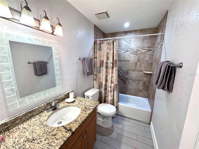 full bath with toilet, shower / tub combo, visible vents, a textured wall, and vanity