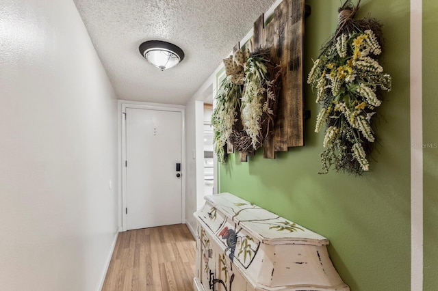 4015 Lake Bayshore Dr Unit 108, Bradenton, FL 34205 - doorway to outside featuring a textured ceiling and light wood-style flooring