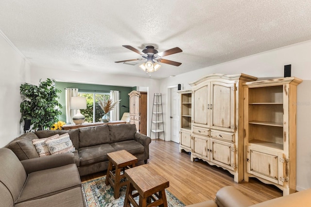 4015 Lake Bayshore Dr Unit 108, Bradenton, FL 34205 - living room featuring light wood finished floors, a textured ceiling, and a ceiling fan