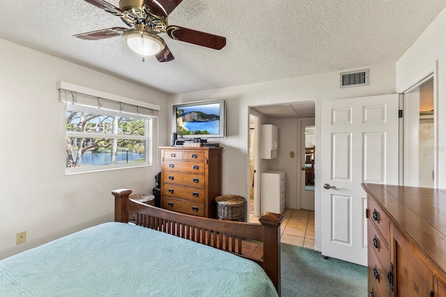 4015 Lake Bayshore Dr Unit 108, Bradenton, FL 34205 - bedroom featuring a ceiling fan, carpet, a textured ceiling, visible vents, and tile patterned flooring