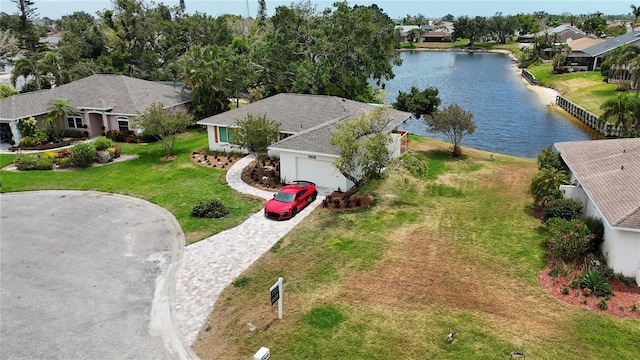 birds eye view of property with a water view and a residential view