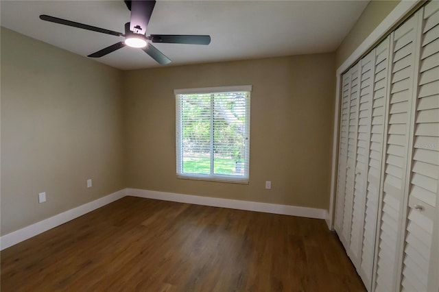unfurnished bedroom with baseboards, ceiling fan, a closet, and wood finished floors