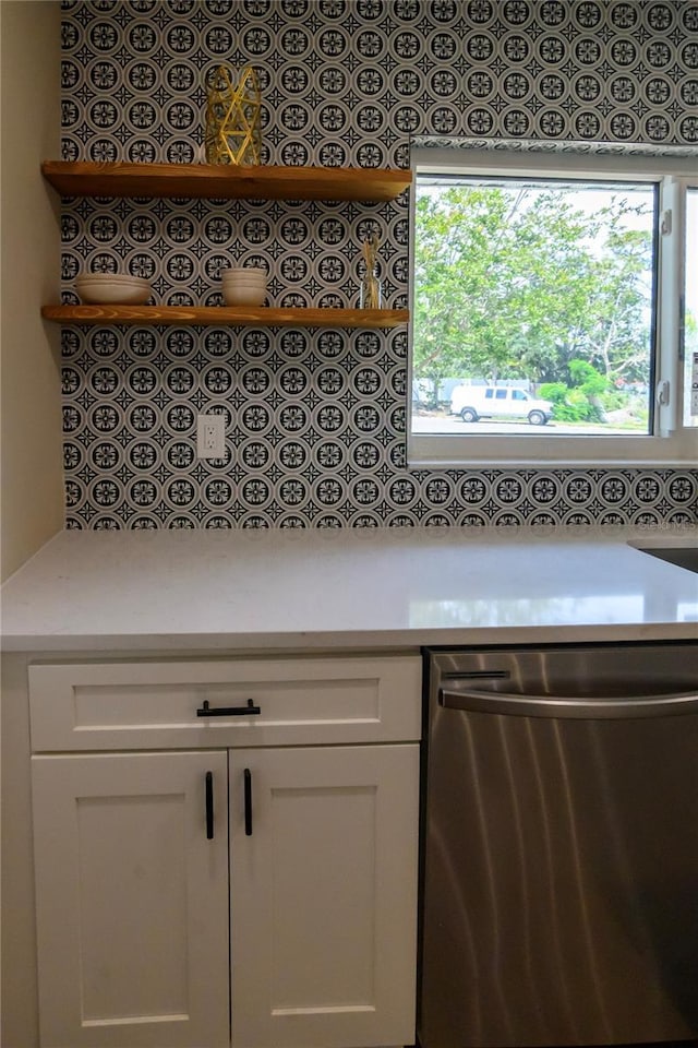 interior space featuring light countertops, open shelves, white cabinets, and dishwasher