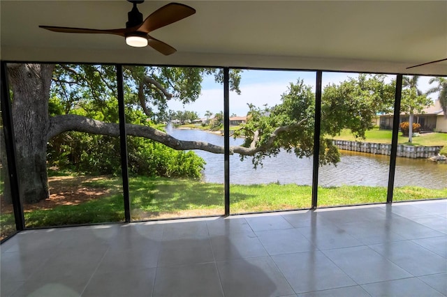 unfurnished sunroom featuring a water view and a wealth of natural light