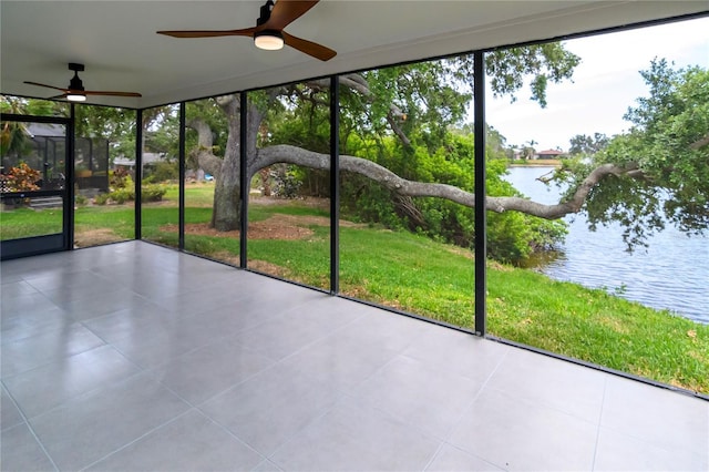 unfurnished sunroom with a water view and ceiling fan