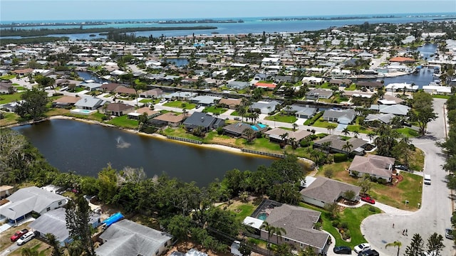 birds eye view of property with a water view and a residential view