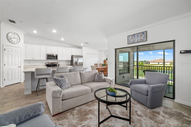 living room with baseboards, visible vents, ornamental molding, and vaulted ceiling