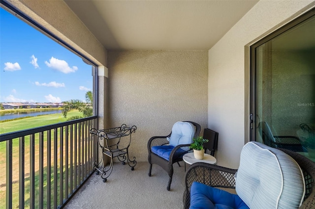 balcony with a water view and golf course view