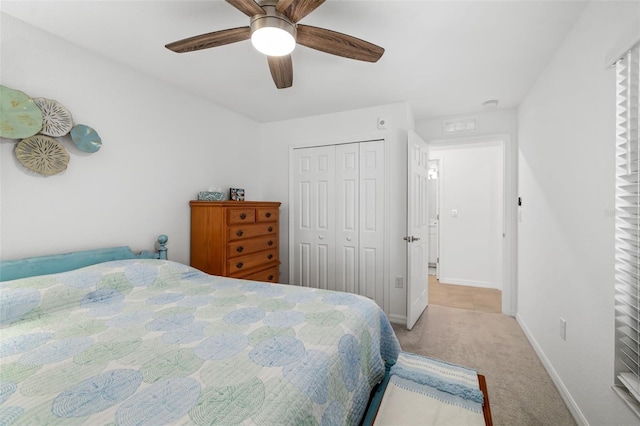 bedroom featuring carpet flooring, baseboards, ceiling fan, and a closet