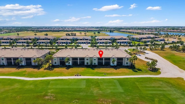 birds eye view of property with a water view, a residential view, and golf course view
