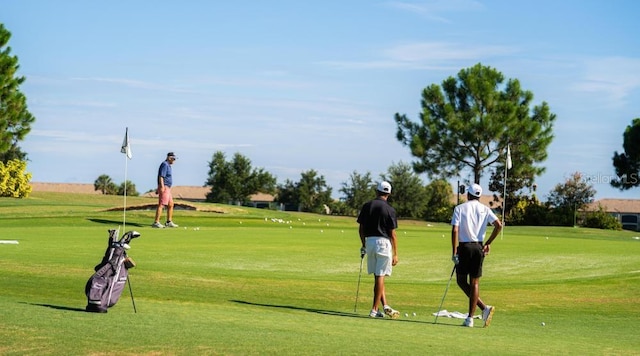 view of property's community with a lawn and golf course view