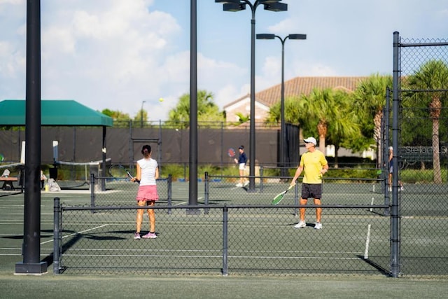view of sport court featuring fence