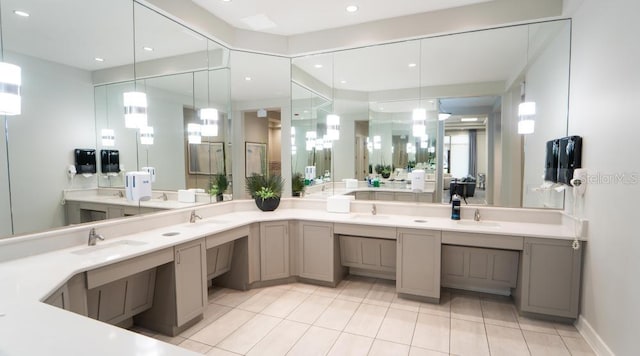 bathroom with tile patterned flooring, a sink, and double vanity