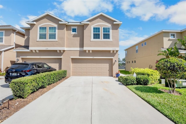 view of front of home with a garage, stucco siding, and driveway