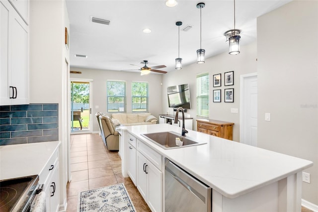 kitchen with plenty of natural light, stainless steel appliances, a ceiling fan, and a sink