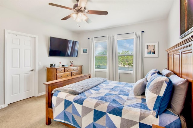 bedroom with baseboards, a ceiling fan, and light carpet