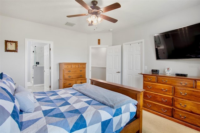 bedroom featuring visible vents, a ceiling fan, and ensuite bathroom
