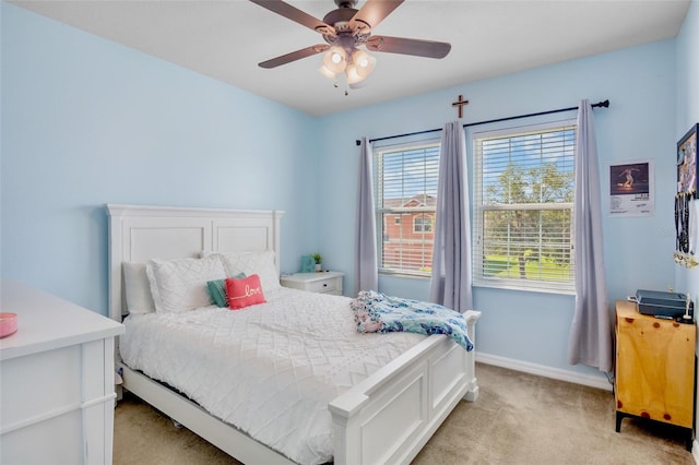 bedroom with a ceiling fan, baseboards, and light colored carpet