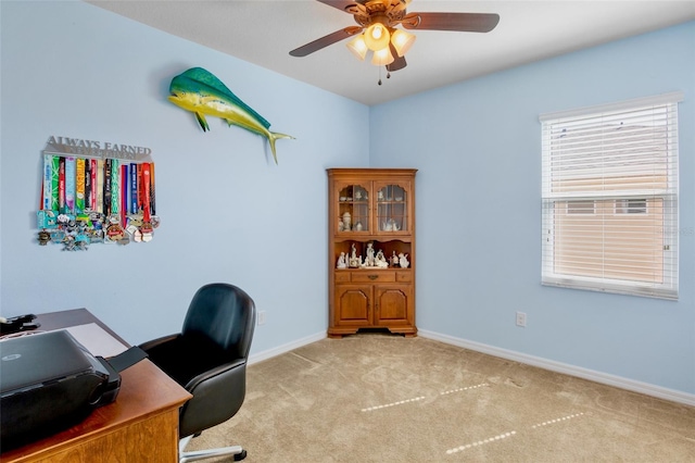 office with baseboards, ceiling fan, and light colored carpet
