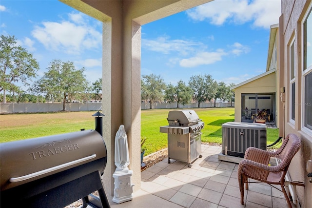 view of patio / terrace featuring central AC unit, fence, and a grill