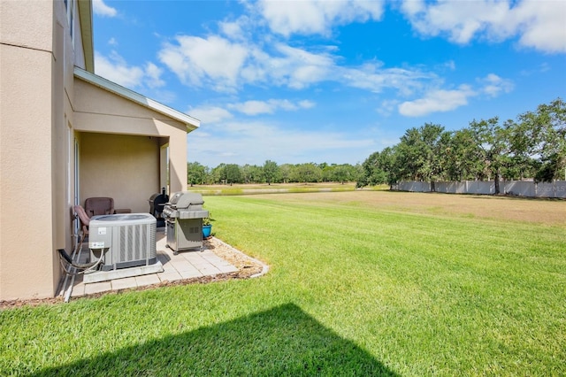 view of yard with central air condition unit, fence, and a patio area