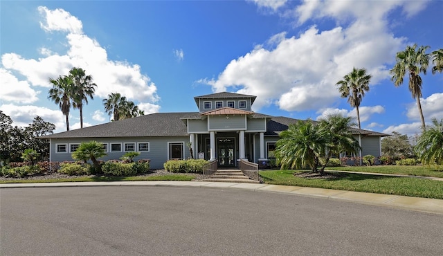 view of front of home with french doors and a front lawn