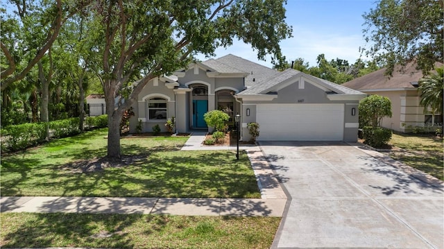 6617 Cheswick St, Sarasota, FL 34243 - ranch-style house featuring a front lawn, fence, stucco siding, an attached garage, and driveway
