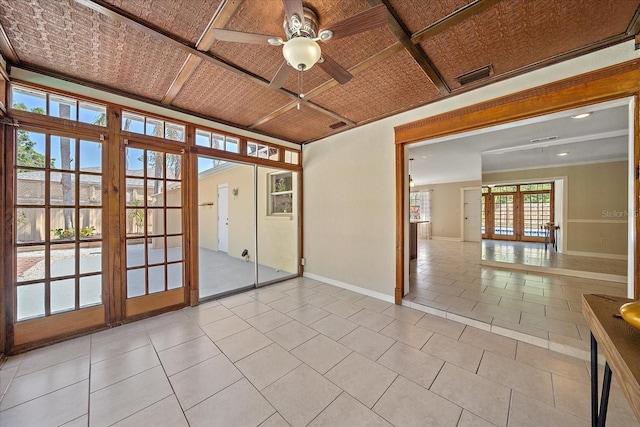 spare room with french doors, light tile patterned floors, baseboards, and ceiling fan