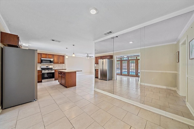 kitchen with visible vents, crown molding, open floor plan, light countertops, and appliances with stainless steel finishes