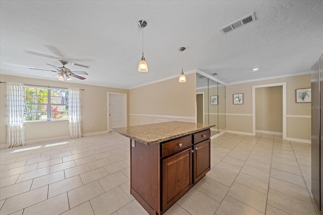 kitchen with a ceiling fan, open floor plan, visible vents, and ornamental molding