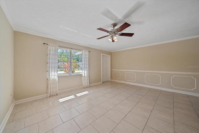 empty room with crown molding, light tile patterned floors, baseboards, and a ceiling fan