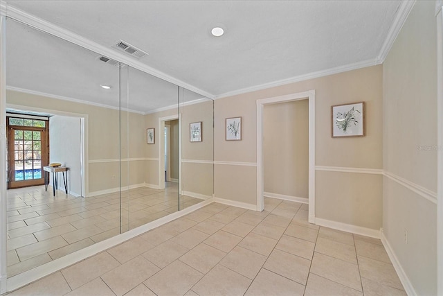 unfurnished room featuring crown molding, baseboards, visible vents, and light tile patterned floors