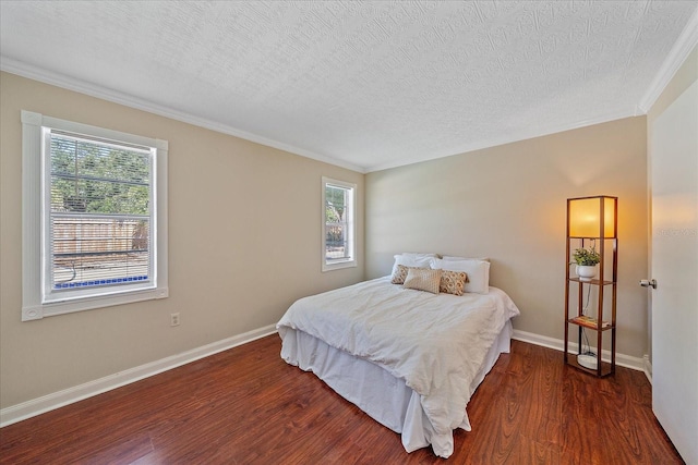bedroom with dark wood-type flooring, a textured ceiling, and multiple windows