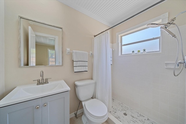 bathroom featuring vanity, baseboards, toilet, and tiled shower