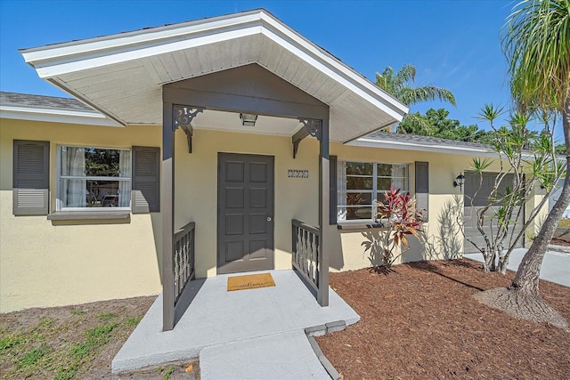 property entrance with stucco siding