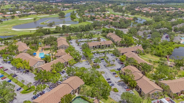 bird's eye view with golf course view, a water view, and a residential view