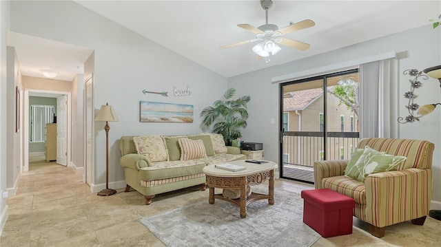 living room with vaulted ceiling, baseboards, and a ceiling fan