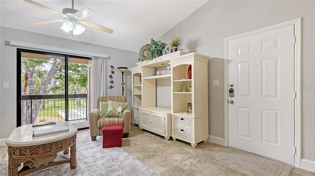 living area with vaulted ceiling, baseboards, and a ceiling fan